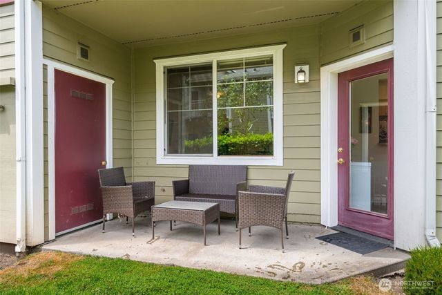 a view of a house with backyard and sitting area