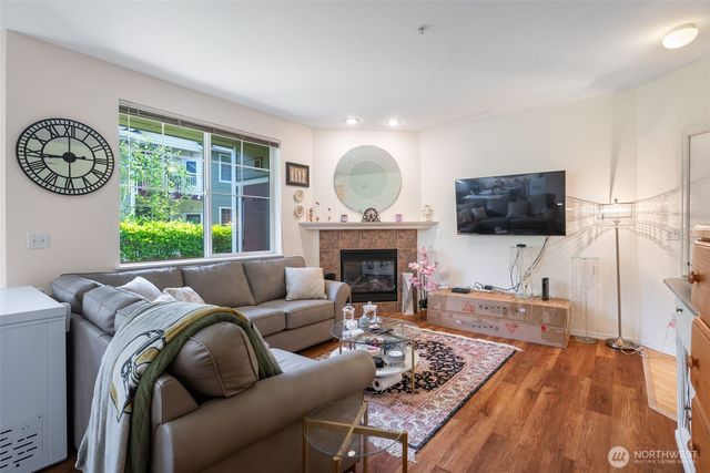a living room with furniture a fireplace and a flat screen tv
