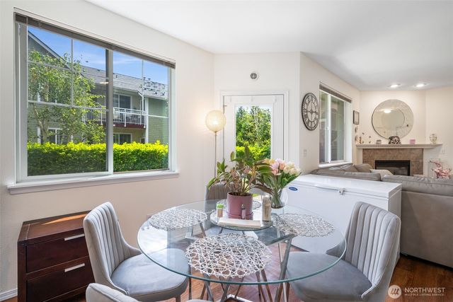 a dining room with furniture window and wooden floor