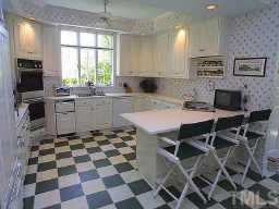 1620 Oberlin Road Raleigh, NC 27608 - Photo 7 of 10 a kitchen with a sink a stove a microwave and cabinets