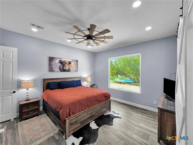 a bedroom with a bed and a flat screen tv