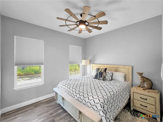 a bedroom with a large bed and a window