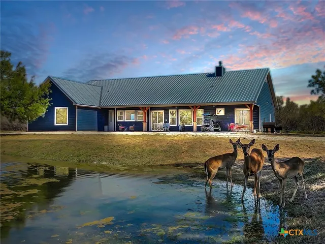 a view of house with outdoor space and sitting area