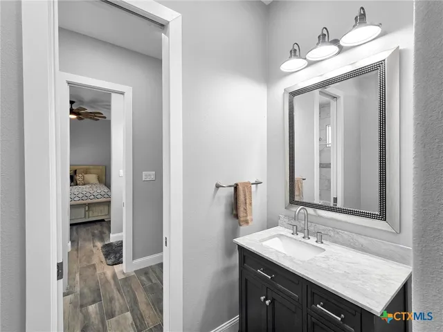 a en suite bathroom with a sink and a mirror