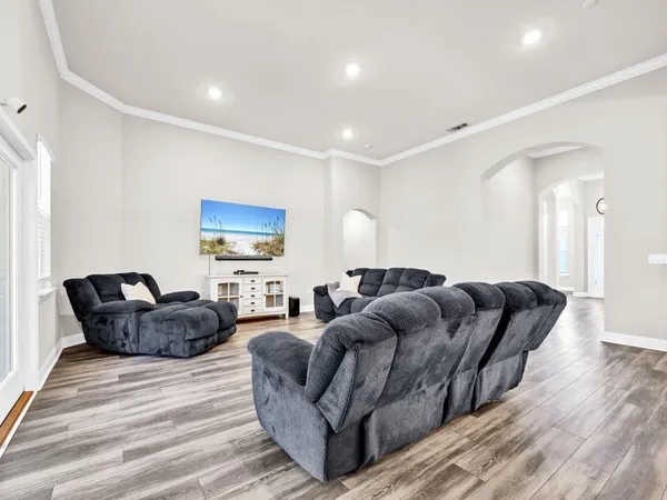 a living room with furniture and wooden floor