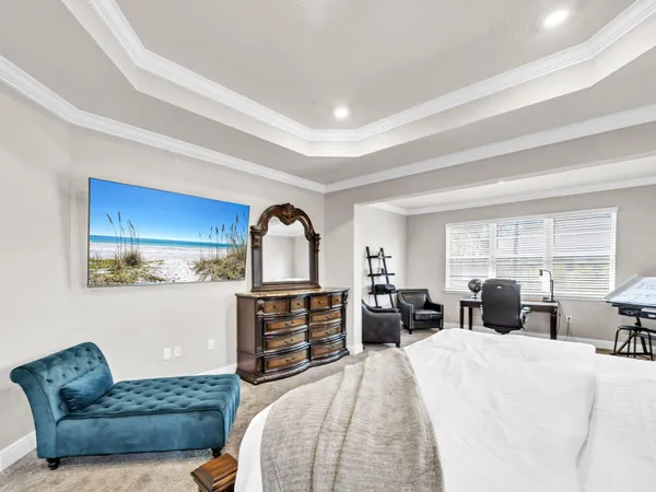 a bedroom with furniture and a large window