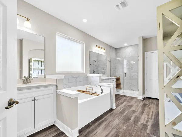 a bathroom with a shower sink and mirror