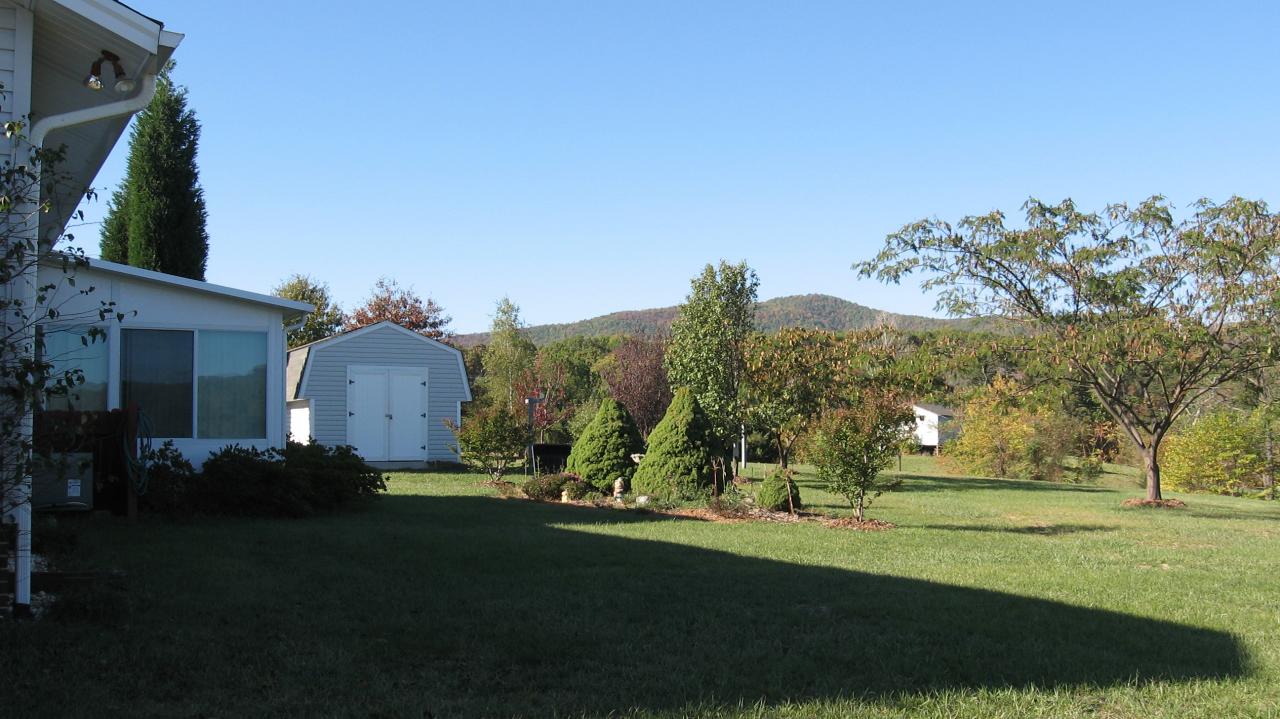 167 Stonebridge Drive Blue Ridge, VA 24064 - Photo 2 of 4 a view of a house with a yard and tree s