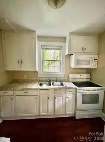 a kitchen with a stove a sink and a refrigerator