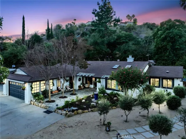 a view of a patio with table and chairs and potted plants