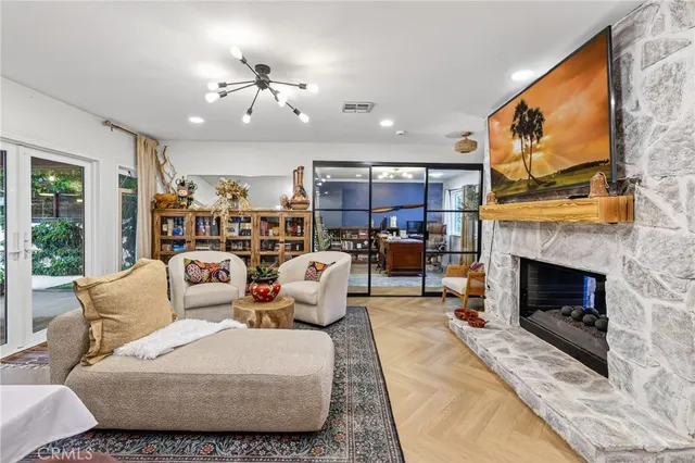 a living room with furniture a fireplace and a flat screen tv