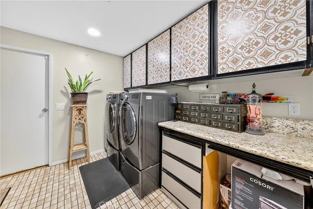 a view of a patio with a table and chairs under an umbrella