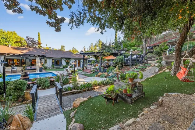 a view of a multi story residential apartment building with a yard and potted plants