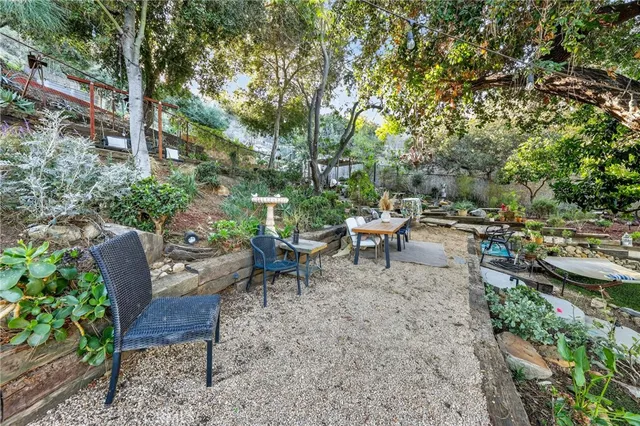 a view of a patio with table and chairs potted plants