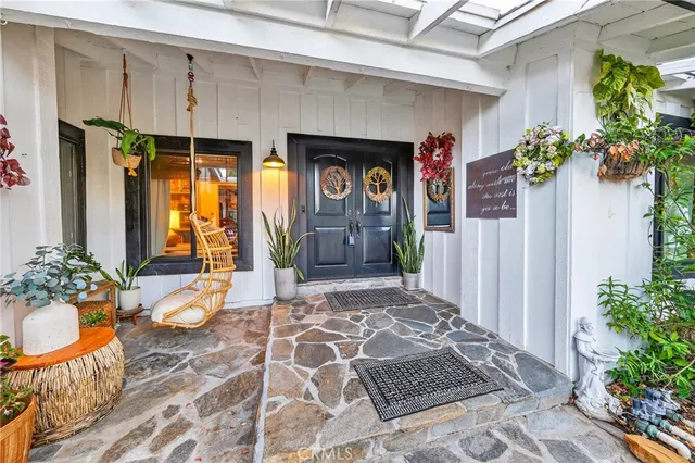 a view of a house with backyard and sitting area
