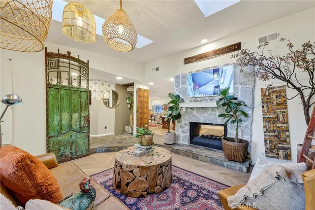 a living room with furniture a fireplace and a chandelier