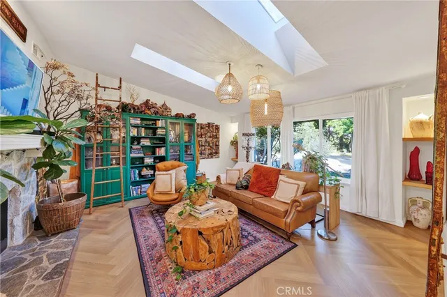 a living room with patio furniture and a potted plant