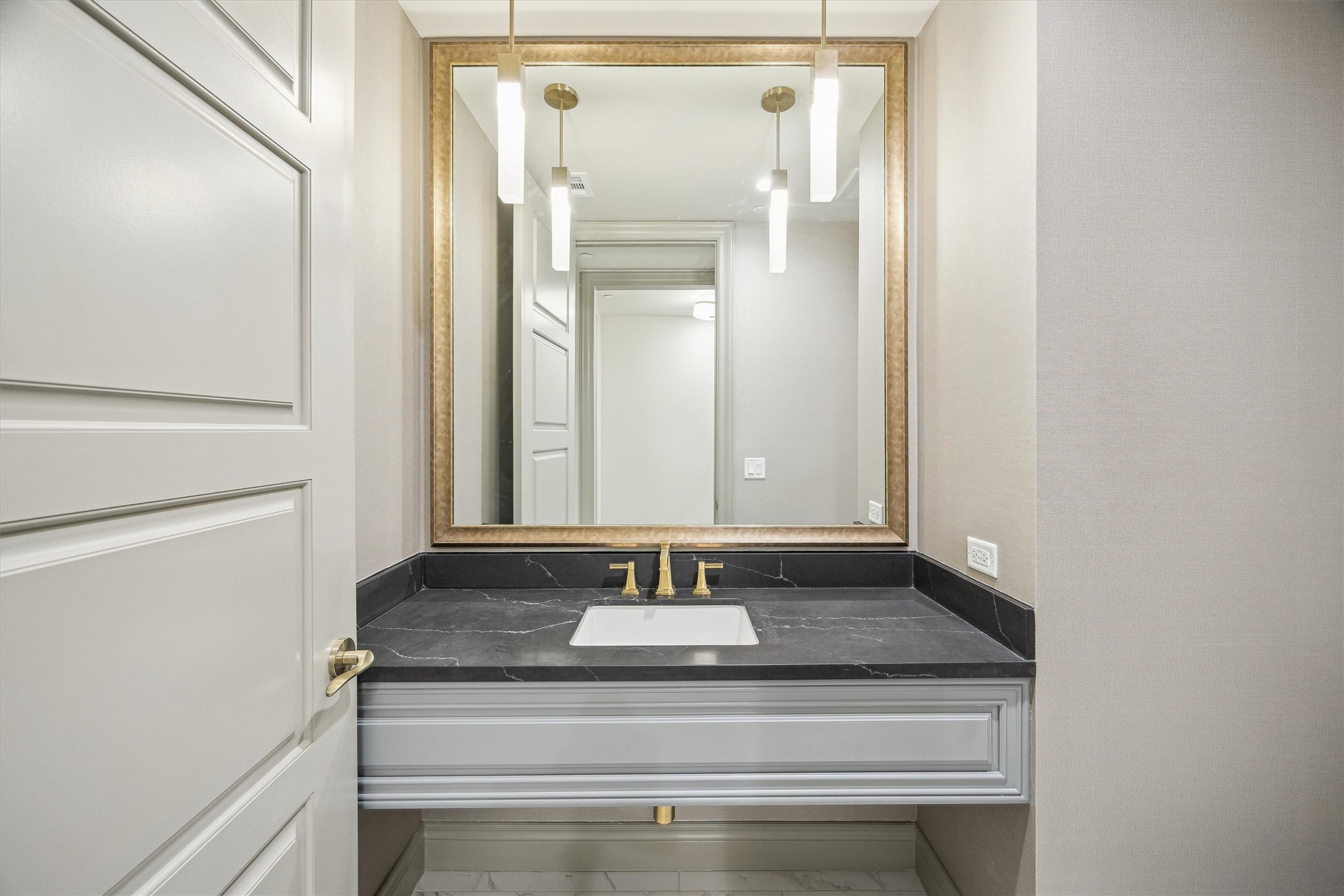 1717 Bissonnet Street, Unit 1802 Houston, TX 77005 - Photo 12 of 46 Half bathroom at the entry with designer wall paper, Quartz counters and designer lighting.