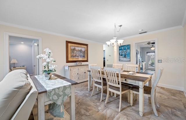457 Boca Ciega Point Boulevard North St. Petersburg, FL 33708 - Photo 7 of 13 a view of a dining room with furniture and chandelier