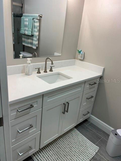 457 Boca Ciega Point Boulevard North St. Petersburg, FL 33708 - Photo 9 of 13 a bathroom with a sink and a mirror