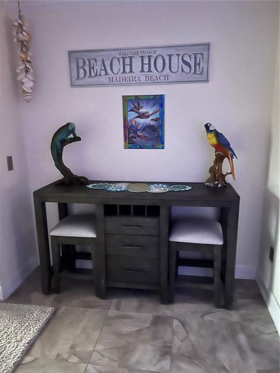 457 Boca Ciega Point Boulevard North St. Petersburg, FL 33708 - Photo 10 of 13 a room with a table and a chair