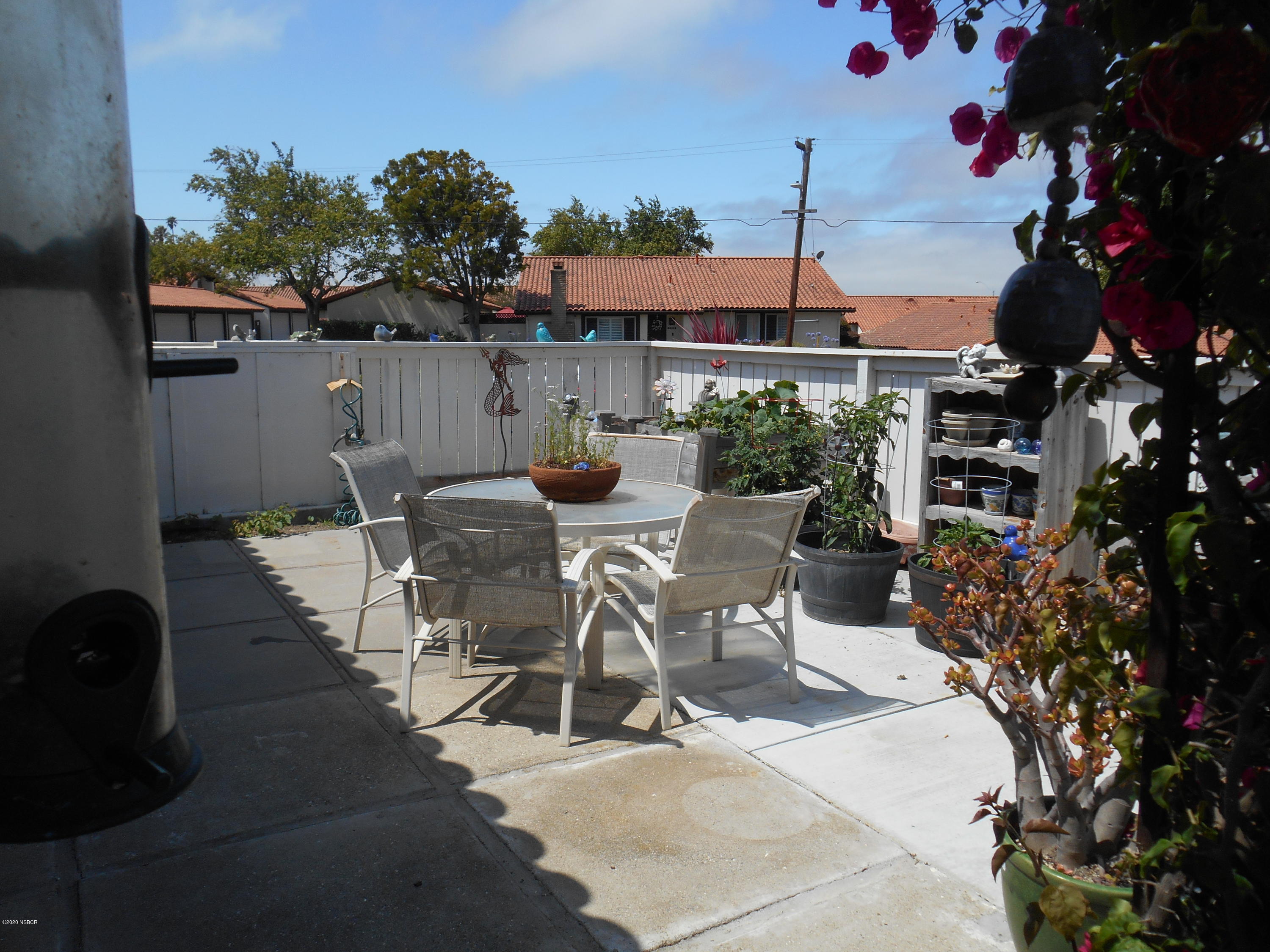 3941 Mesa Cir Drive Lompoc, CA 93436 - Photo 5 of 16 a view of a patio with table and chairs potted plants