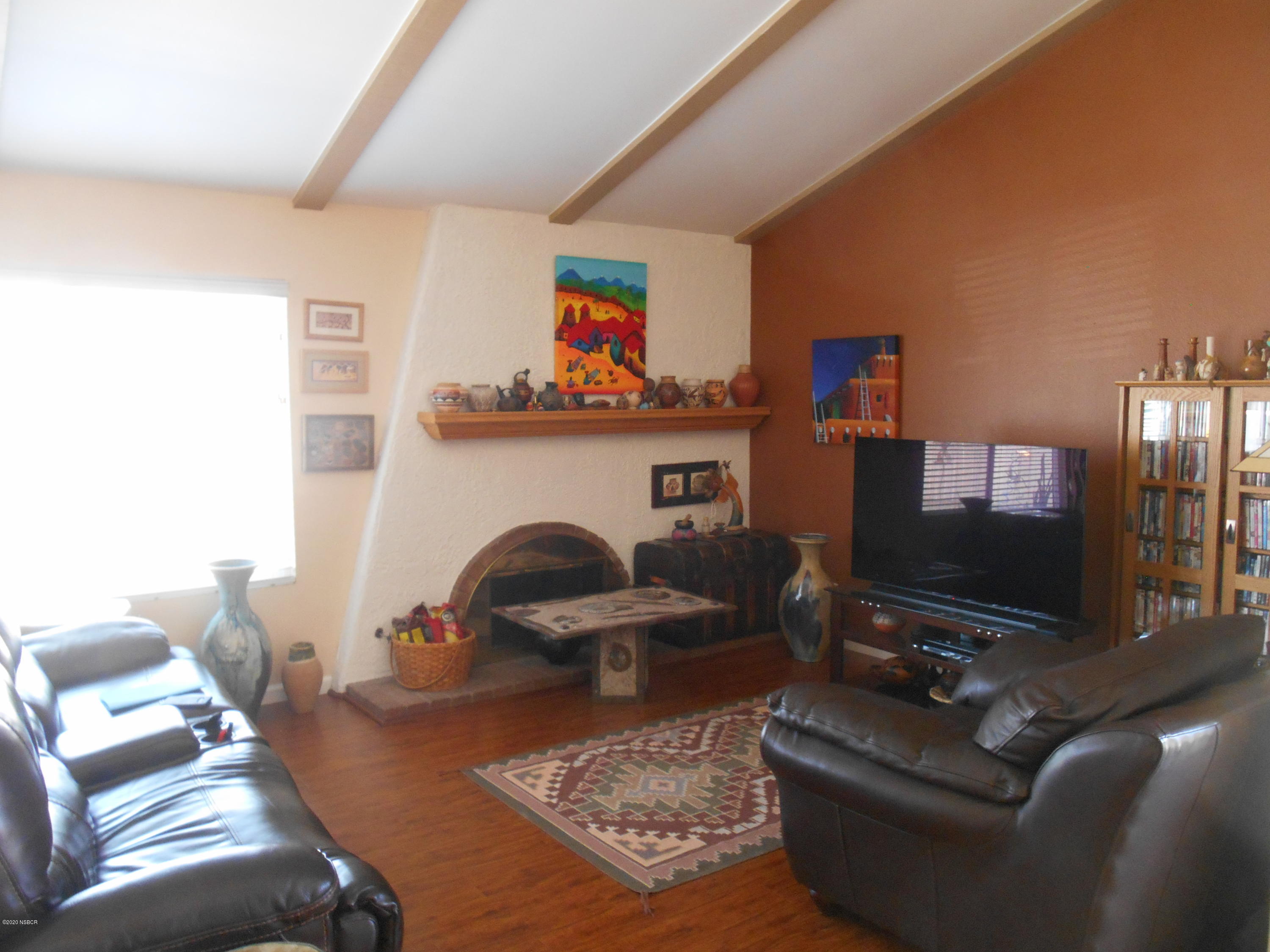 3941 Mesa Cir Drive Lompoc, CA 93436 - Photo 7 of 16 a living room with furniture a flat screen tv and a fireplace