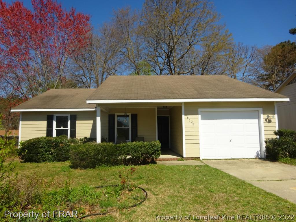6528 Applewhite Road Fayetteville, NC 28304 - Photo 1 of 15 a view of a white house next to a yard and trees