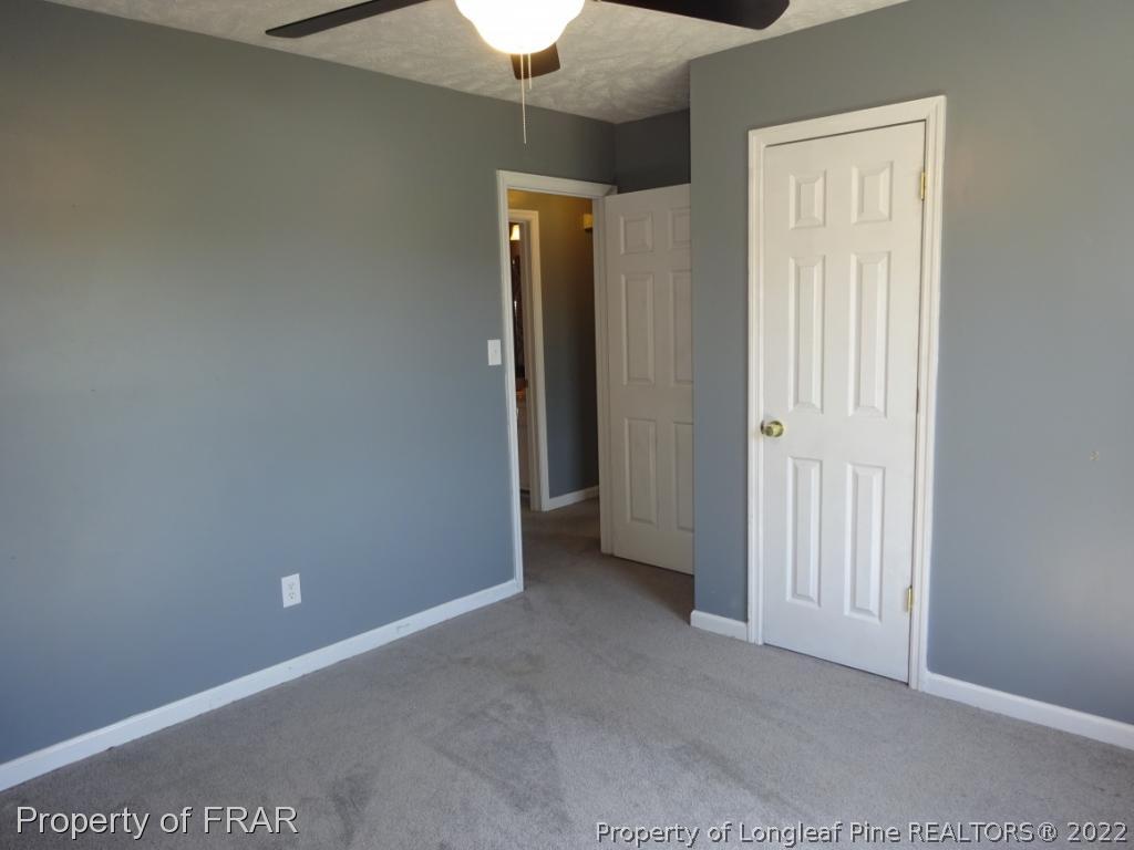 6528 Applewhite Road Fayetteville, NC 28304 - Photo 11 of 15 an empty room with closet and a chandelier fan