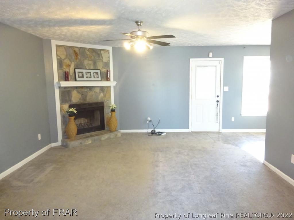 6528 Applewhite Road Fayetteville, NC 28304 - Photo 2 of 15 a view of an empty room with a fireplace