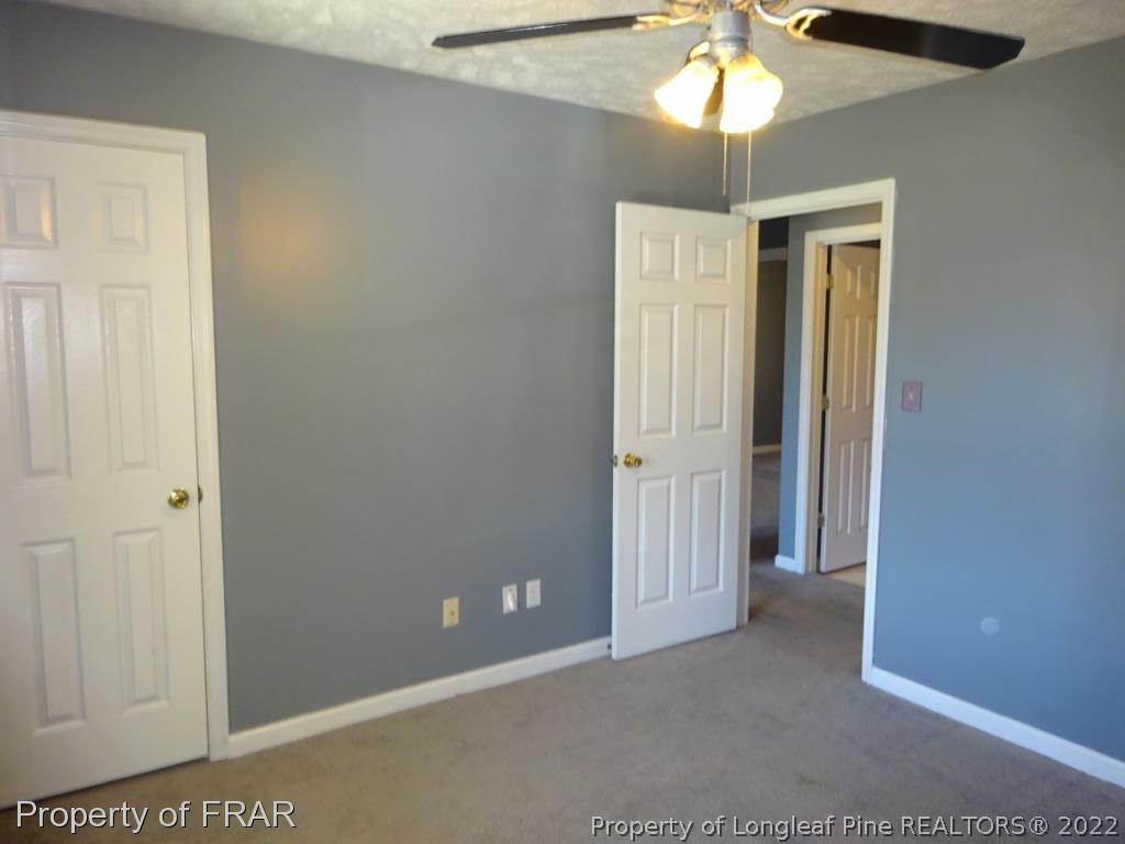 6528 Applewhite Road Fayetteville, NC 28304 - Photo 9 of 15 a view of an empty room and chandelier fan
