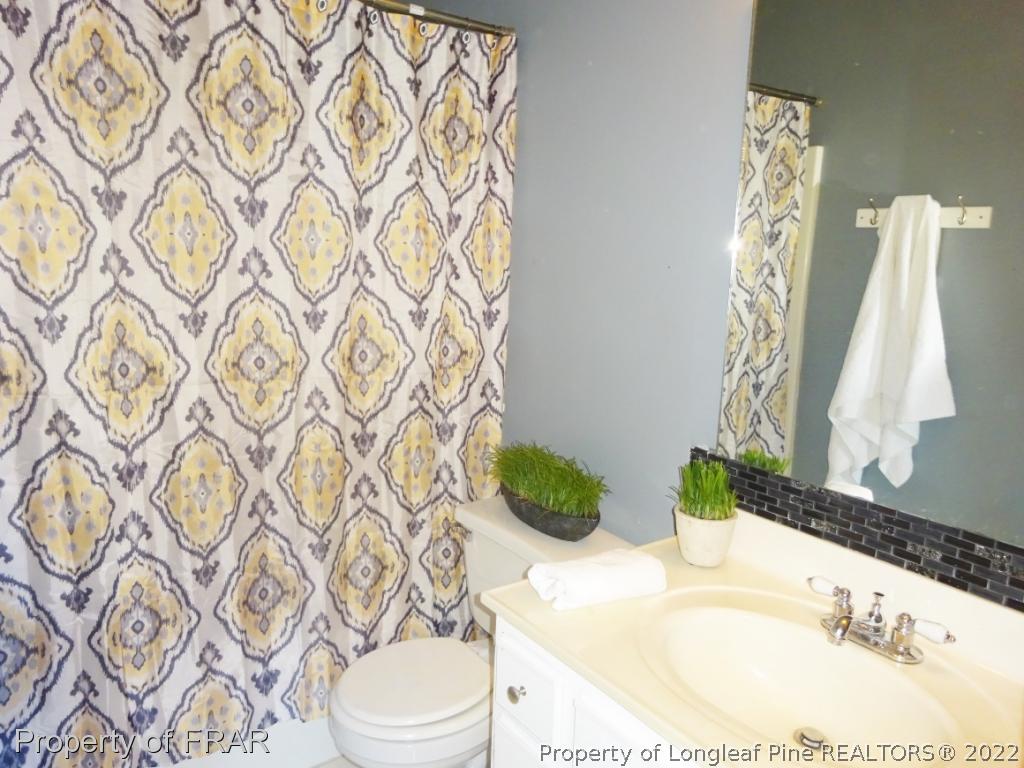 6528 Applewhite Road Fayetteville, NC 28304 - Photo 10 of 15 a bathroom with a sink toilet and shower
