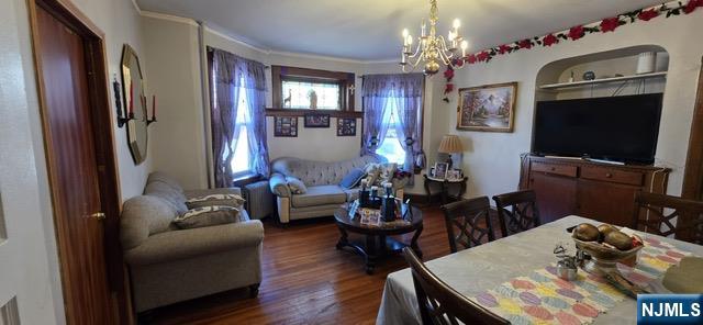 26 Halstead Street Kearny, NJ 07032 - Photo 2 of 11 a living room with furniture a chandelier a rug and a window