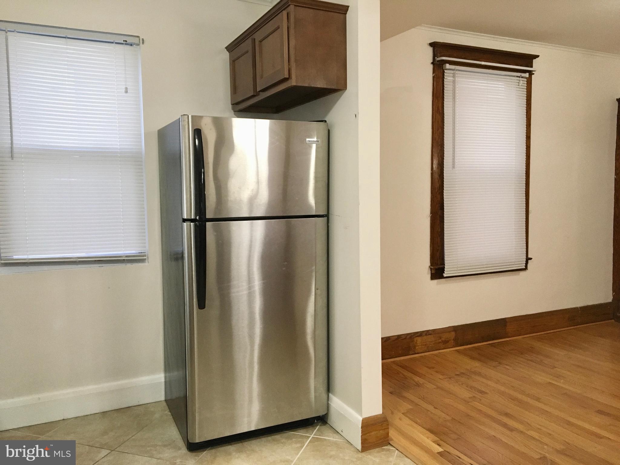 7003 Linden Avenue Baltimore, MD 21206 - Photo 11 of 29 a white refrigerator freezer and a wooden floor