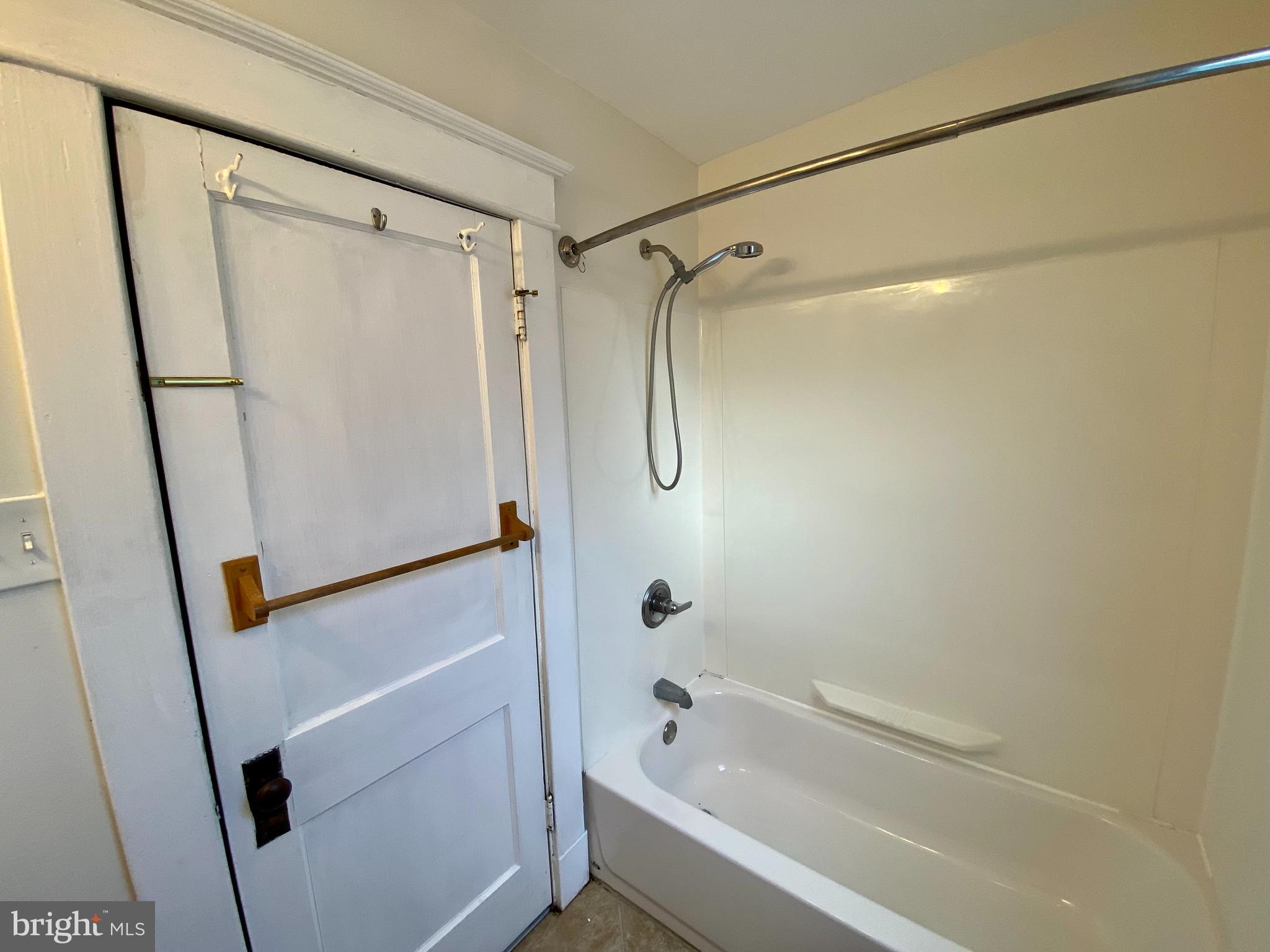 7003 Linden Avenue Baltimore, MD 21206 - Photo 20 of 29 a bathroom with a shower and a tub