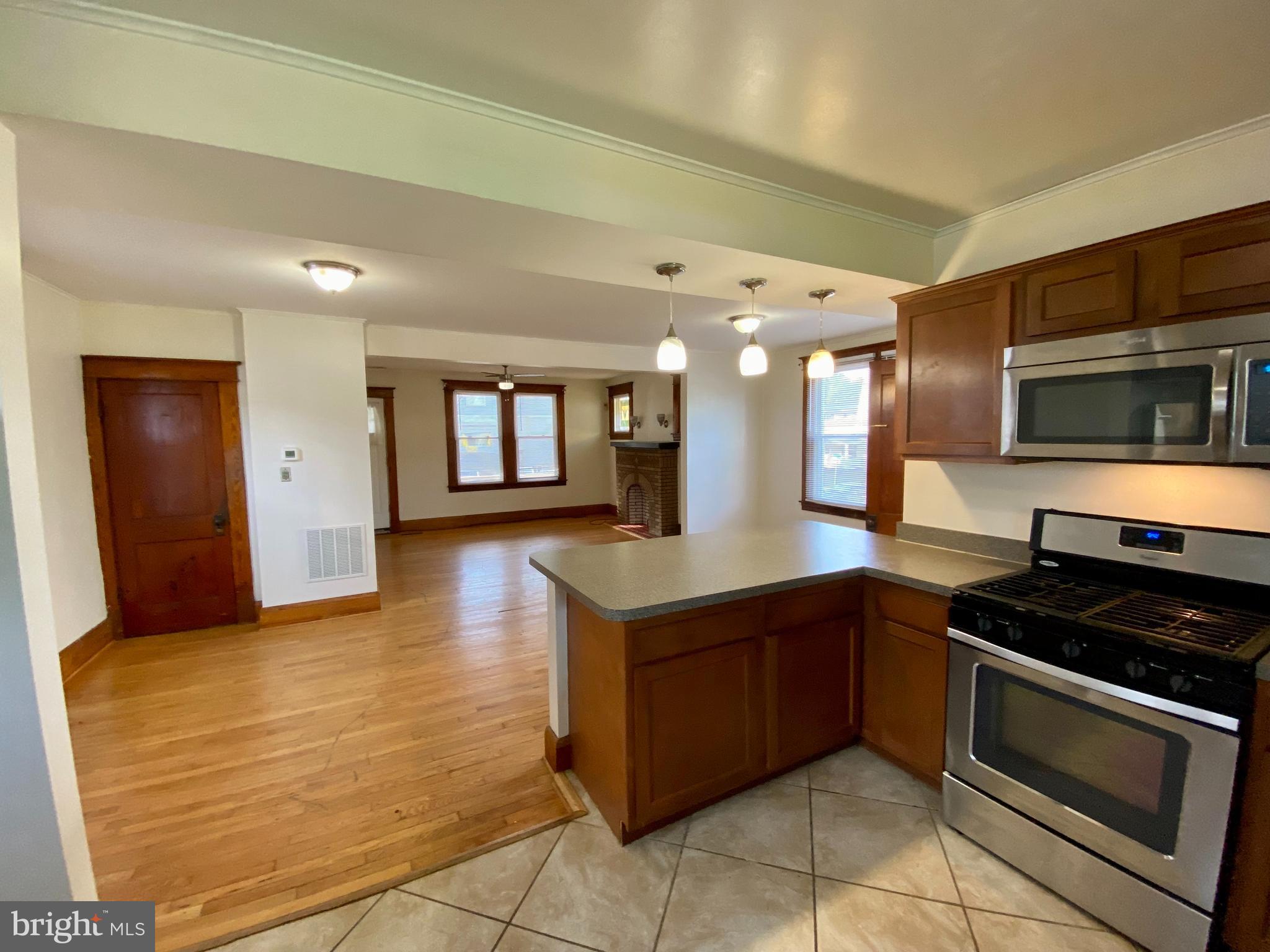 7003 Linden Avenue Baltimore, MD 21206 - Photo 24 of 29 a kitchen with stainless steel appliances granite countertop a stove and a sink