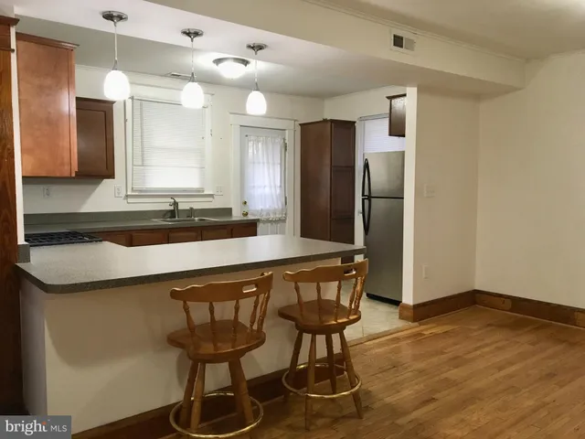 a kitchen with stainless steel appliances a sink and a refrigerator