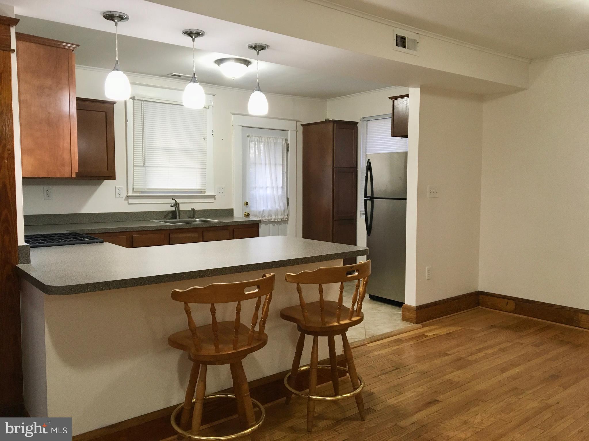 7003 Linden Avenue Baltimore, MD 21206 - Photo 5 of 29 a kitchen with stainless steel appliances a sink and a refrigerator