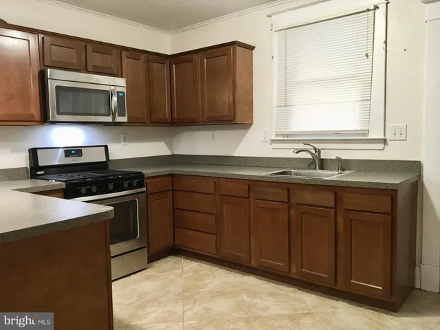 a kitchen with sink and cabinets