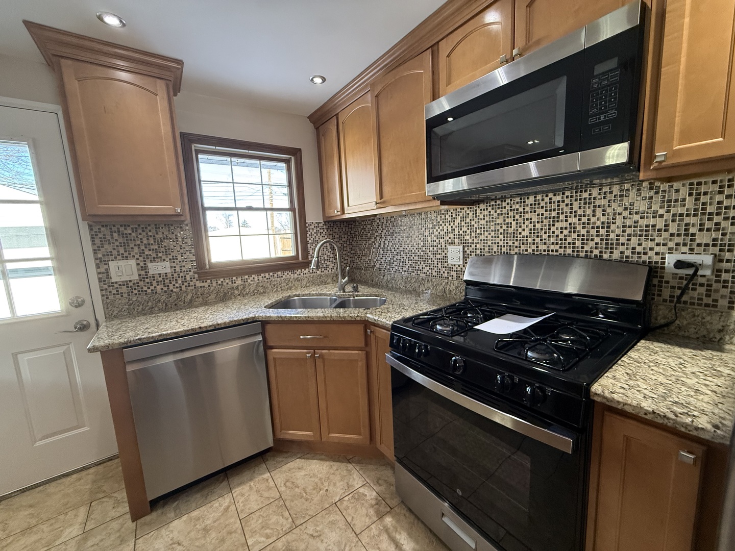 9060 South Main Street Hometown, IL 60456 - Photo 11 of 18 a kitchen with granite countertop a stove sink and microwave