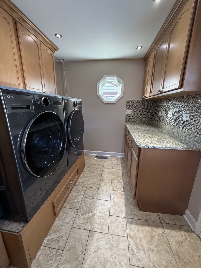 9060 South Main Street Hometown, IL 60456 - Photo 14 of 18 a utility room with wooden cabinets washer and dryer