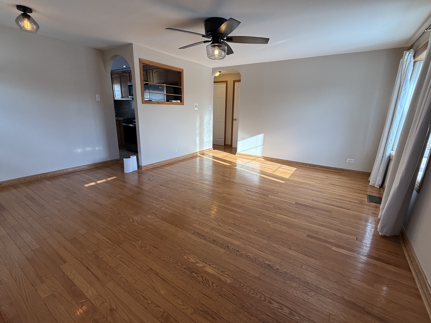 9060 South Main Street Hometown, IL 60456 - Photo 15 of 18 a view of a livingroom with wooden floor and a ceiling fan