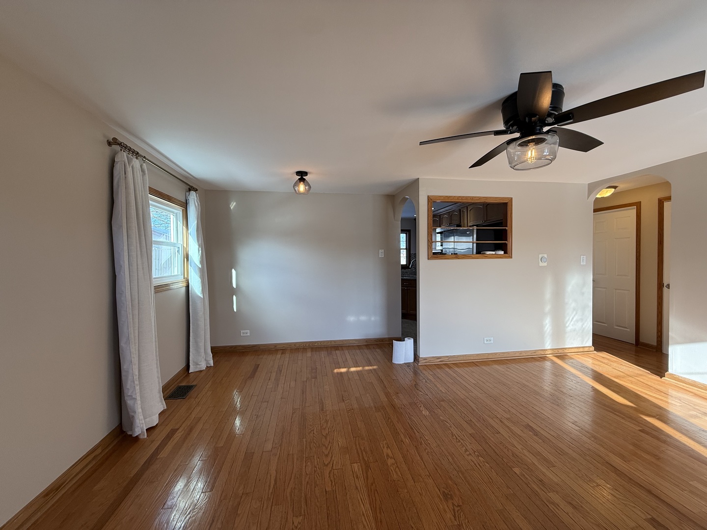 9060 South Main Street Hometown, IL 60456 - Photo 17 of 18 a view of a livingroom with wooden floor and a ceiling fan