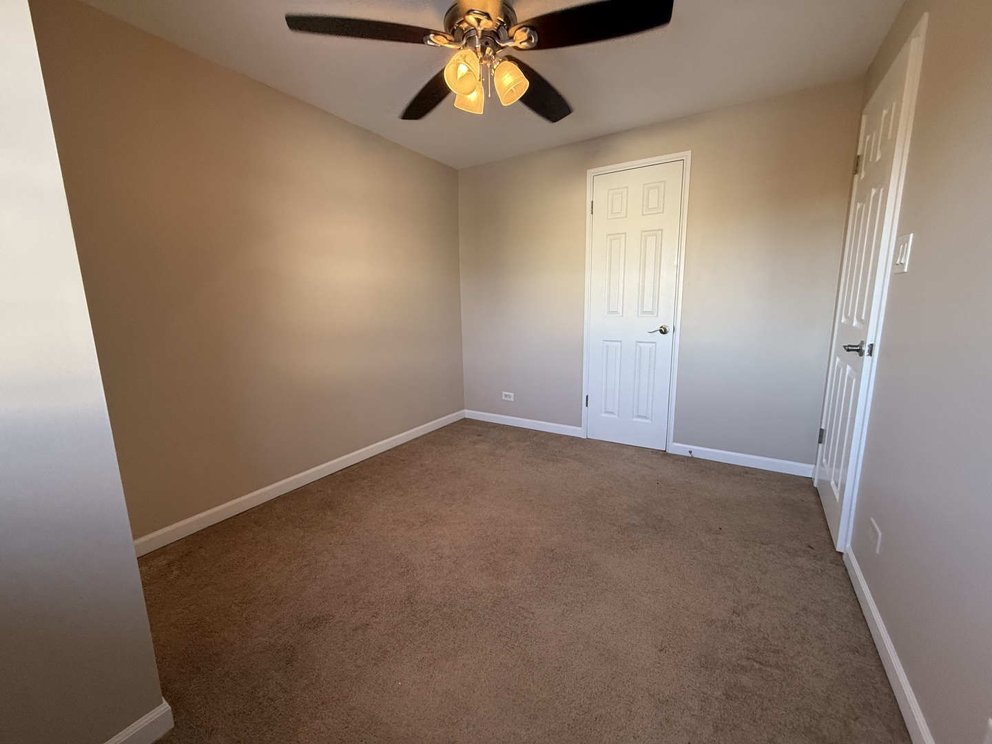 9060 South Main Street Hometown, IL 60456 - Photo 8 of 18 an empty room with windows and fan