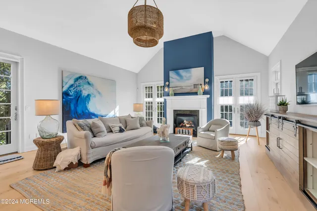 a living room with furniture a fireplace and a large window