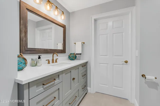 a bedroom with a bed a window and painting on the wall