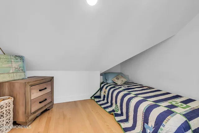 a kitchen with stainless steel appliances a refrigerator and wooden floor