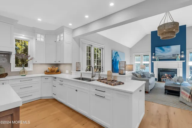 a kitchen with white cabinets and appliances