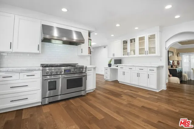 a kitchen with stainless steel appliances granite countertop a stove and a sink
