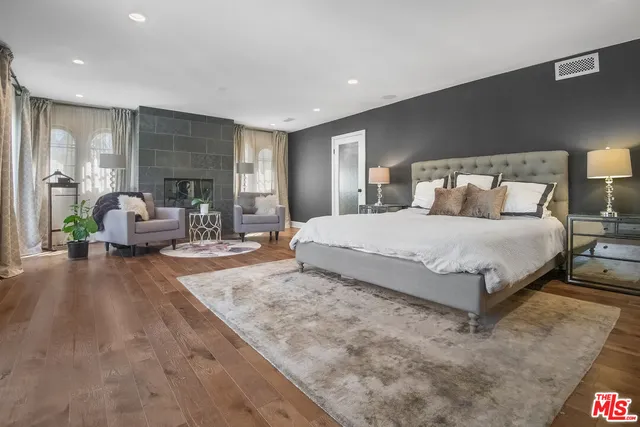 a bedroom with a large bed and a couch